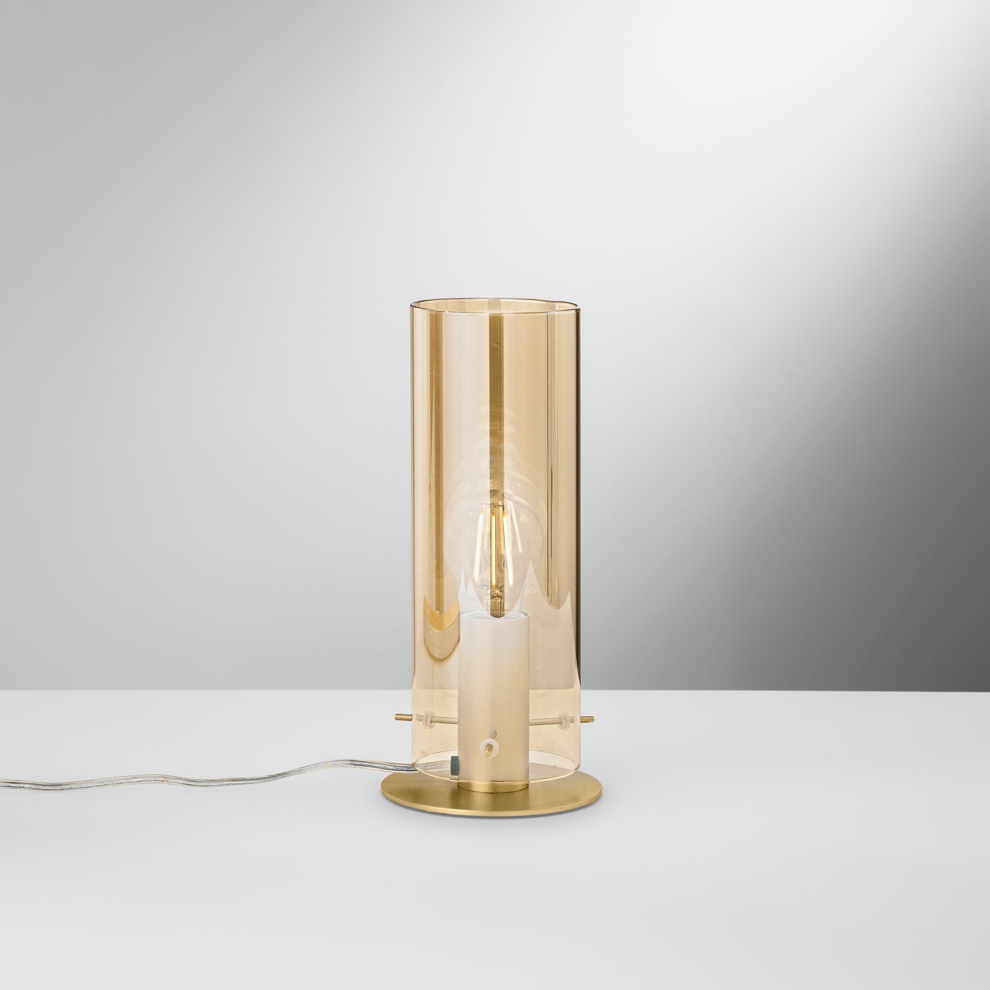 Lampada da tavolo MAGIC in metallo oro e diffusore in vetro ambrato